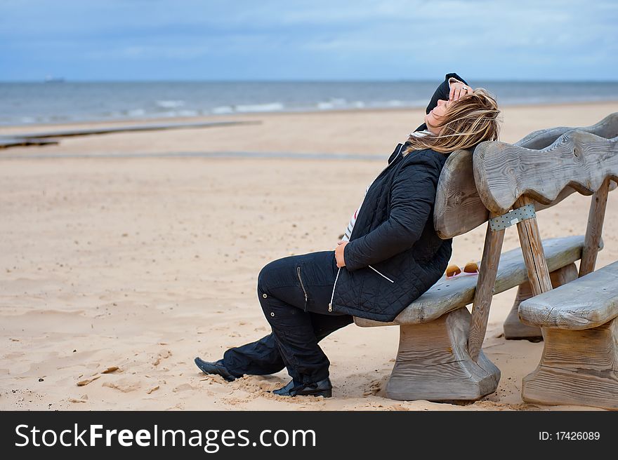 Mature woman relaxing at the Baltic sea in autumn day. Mature woman relaxing at the Baltic sea in autumn day.
