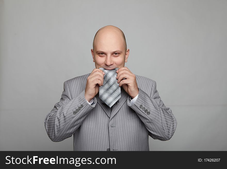 Bald businessman in a gray suit
