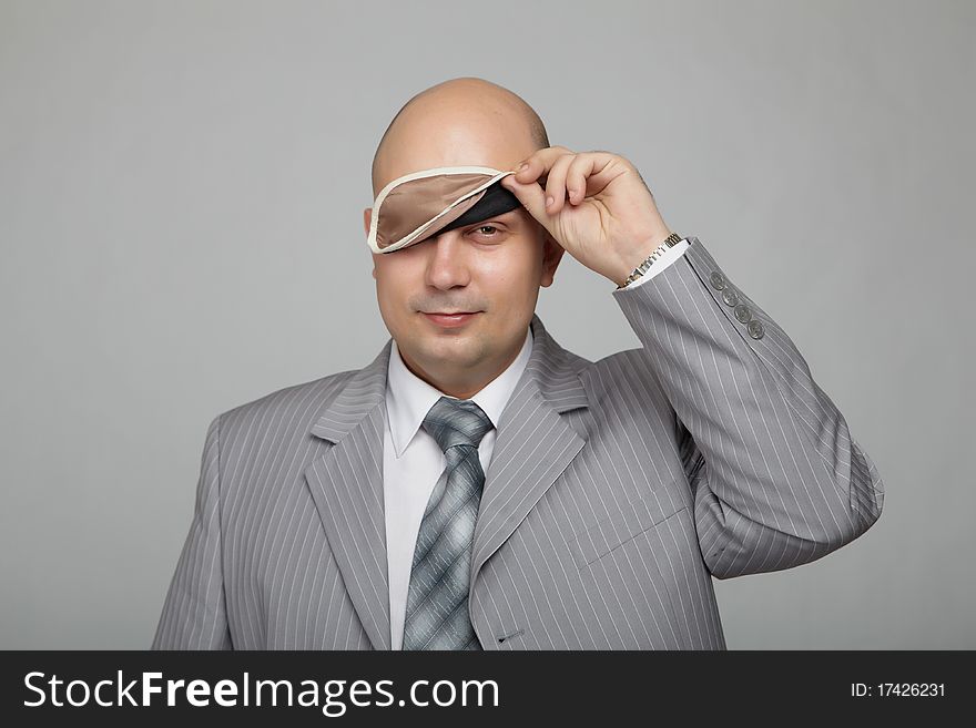 Bald businessman in a gray suit