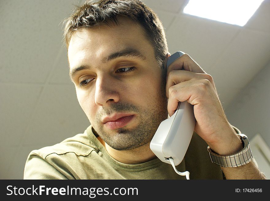 Caucasian man with phone in office