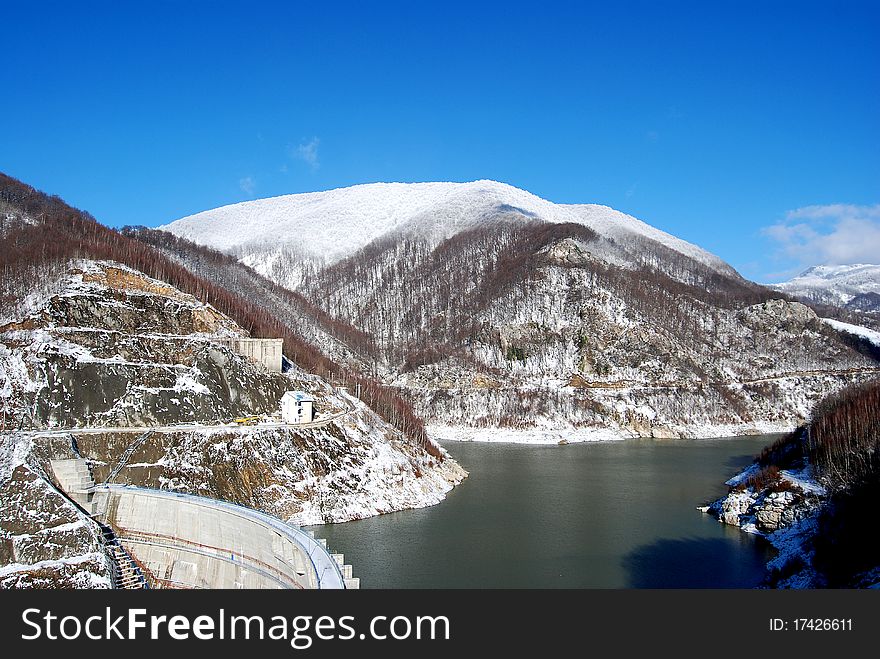 Water dam enclosed by snowy mountains. Water dam enclosed by snowy mountains