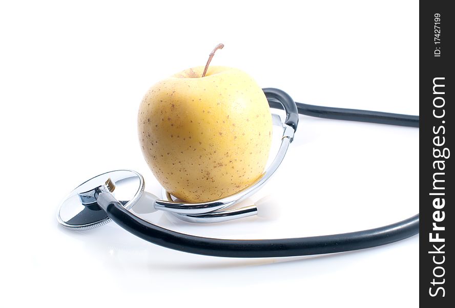 Apple and stethoscope on the white background