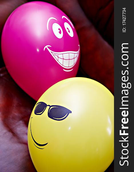 Funny red and yellow balloons with painted smile faces