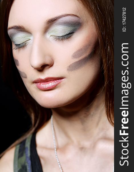 Attractive and girl have military makeup in studio. Attractive and girl have military makeup in studio