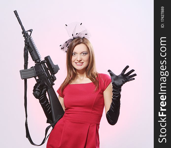 Attractive and spy woman with assault rifle in red. Attractive and spy woman with assault rifle in red