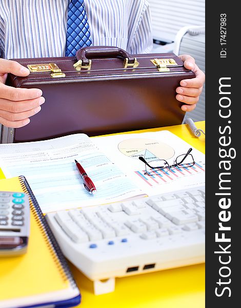 Businessman holding a brown case. Businessman holding a brown case