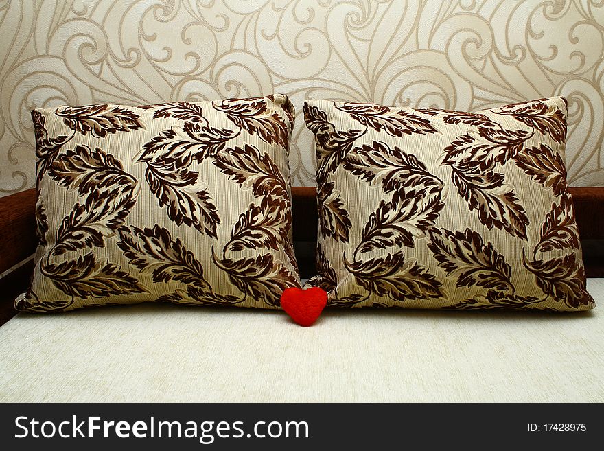 Two pillows and red heart near it. Two pillows and red heart near it