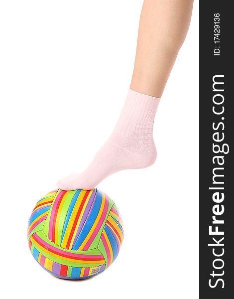 Close-up of human legs with a multicolored ball isolated on white