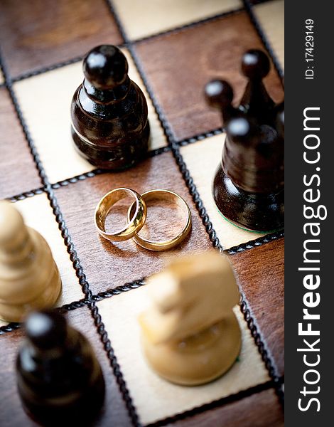 Wedding rings and chess, shallow DOF