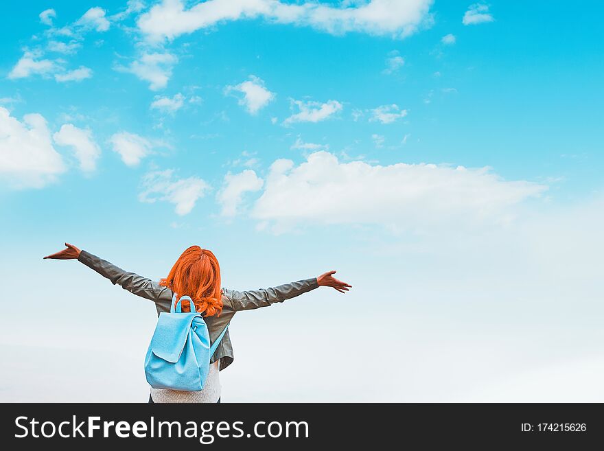 Young redhead woman with backpack enjoying summer day against sky. Freedom of zen. Young redhead woman with backpack enjoying summer day against sky. Freedom of zen