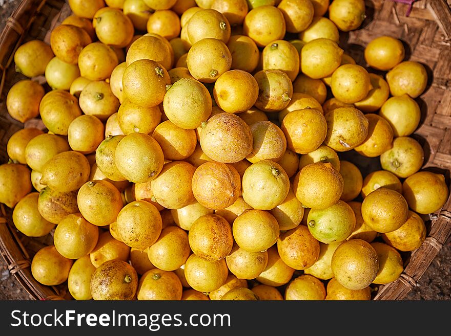 A basket full of yellow limes on sale at Zegyo market, Mandalay, Myanmar. A basket full of yellow limes on sale at Zegyo market, Mandalay, Myanmar.