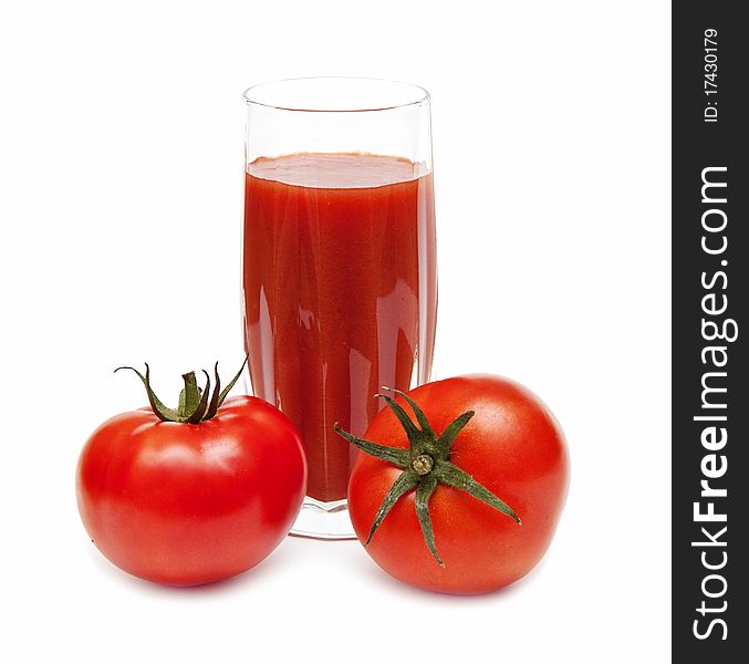 Fresh tomatoes and a glass full of tomato juice on white