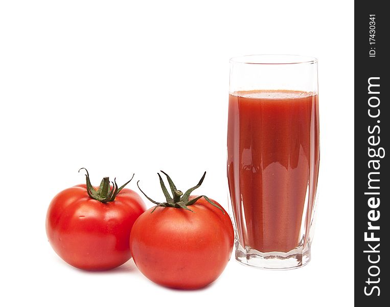 Fresh tomatoes and a glass full of tomato juice on white