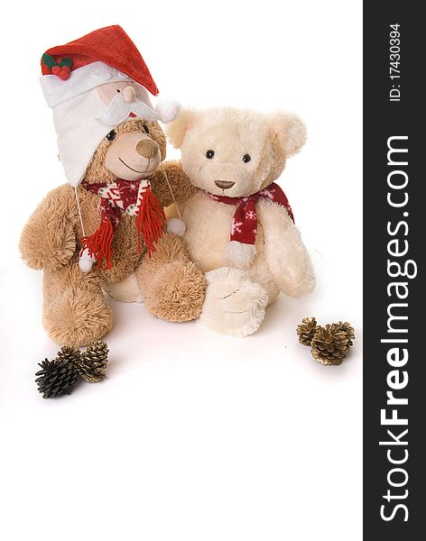 Two teddy bears shot in a christmas theme hi key style cuddling each other. Two teddy bears shot in a christmas theme hi key style cuddling each other