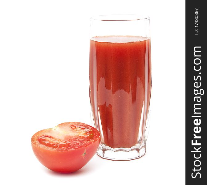 Fresh tomatoes and a glass full of tomato juice on white