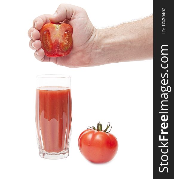 Juice from tomato in male hand on white