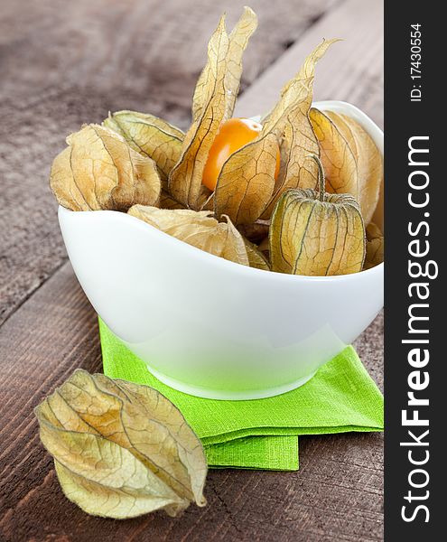 Fresh gooseberries (physalis) in bowl on napkin. Fresh gooseberries (physalis) in bowl on napkin