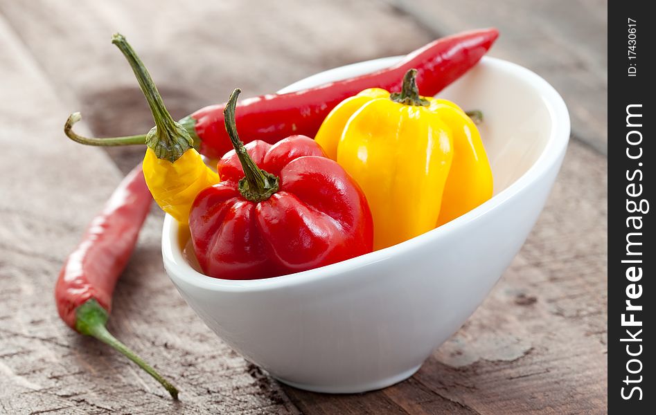 Fresh chili pepper and habanero in white bowl. Fresh chili pepper and habanero in white bowl