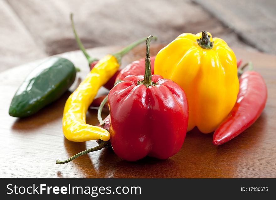 Mixed chillies on cutting board. Mixed chillies on cutting board