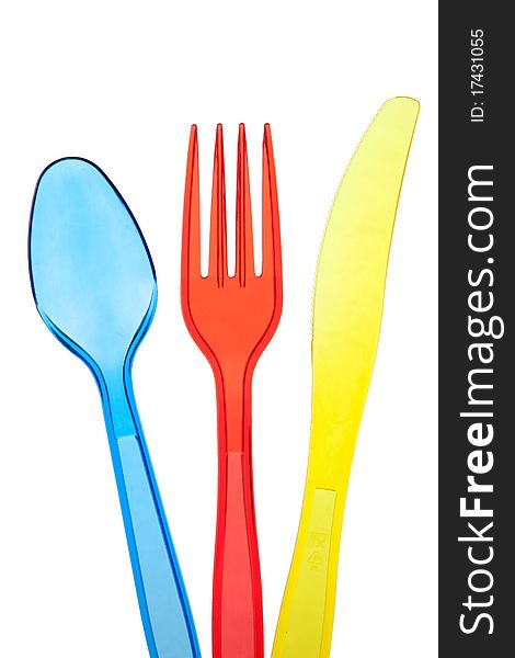 Dark blue plastic spoon, red plastic plug and yellow plastic knife. Dark blue plastic spoon, red plastic plug and yellow plastic knife