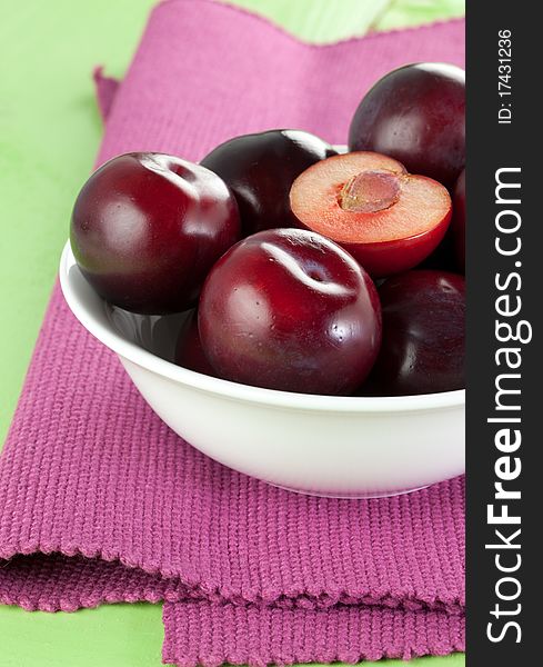 Red plums in a bowl