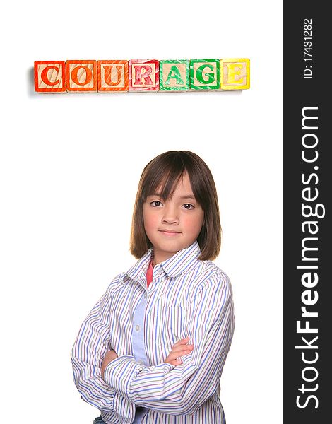 A young student showing couragous pose under word blocks. A young student showing couragous pose under word blocks.