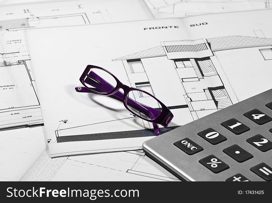 Calculator and eyeglasses with technical drawings. Calculator and eyeglasses with technical drawings