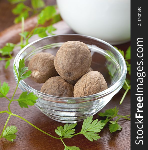 Nutmegs in a bowl with chervil
