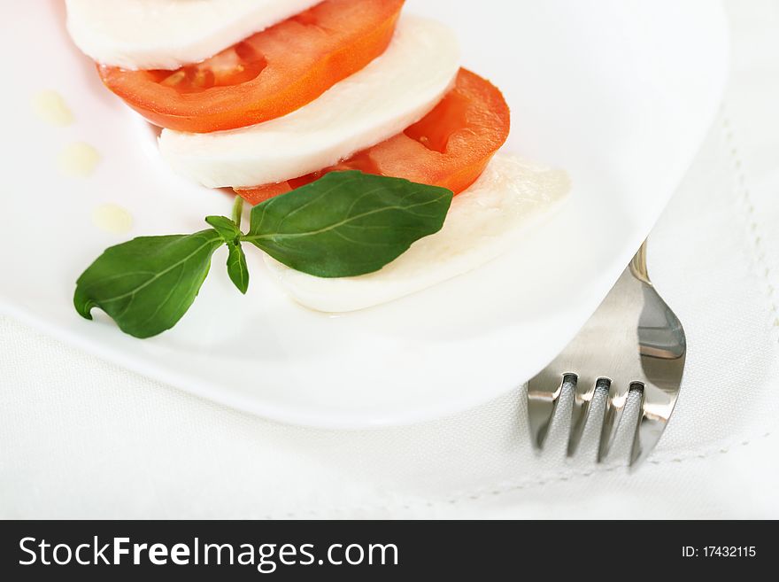 Caprese salad - mozzarella with tomatoes, basil and olive oil
