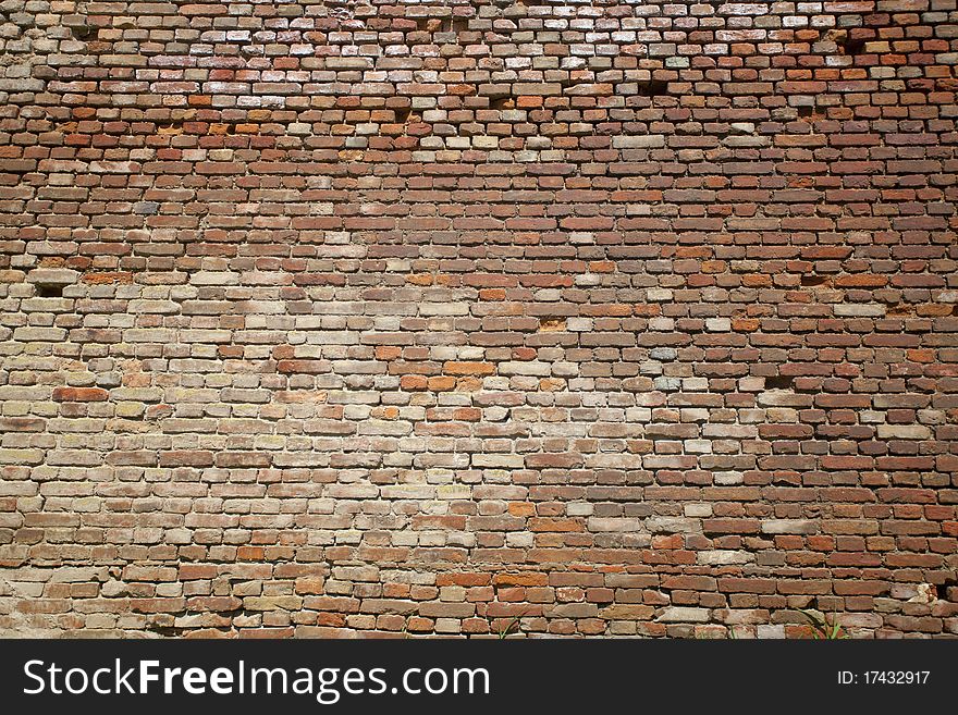 Broken and very old brick wall