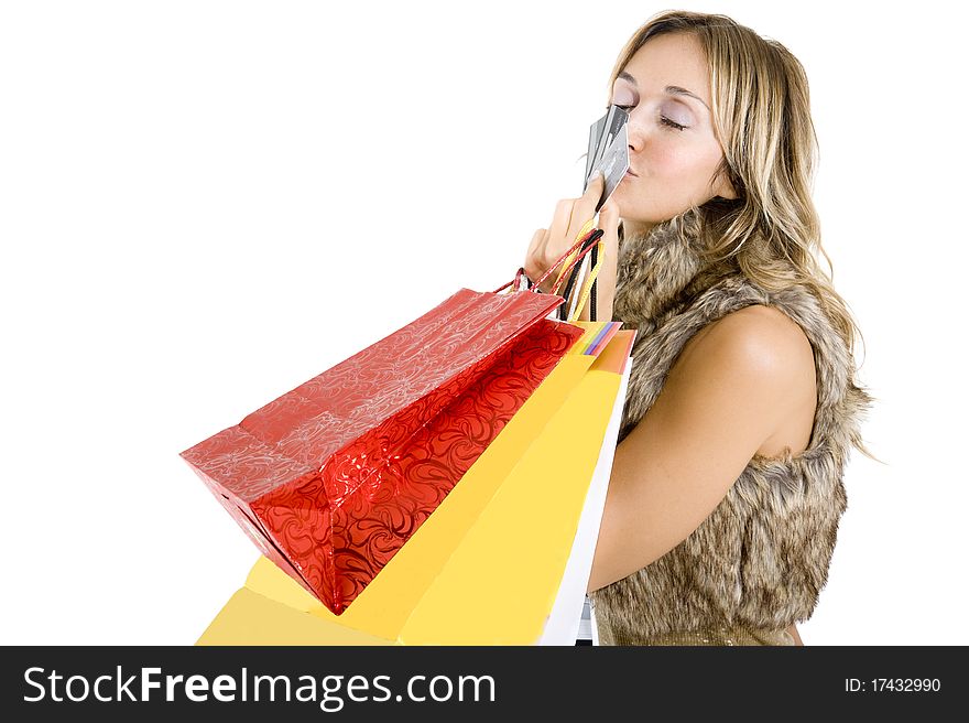 Sexy blond woman with shopping bags smiling happily