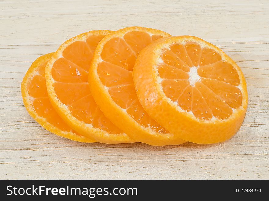 Orange slices on wood background