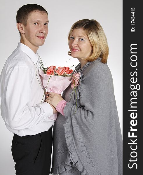 The man and the woman hold a bouquet and look in a shot