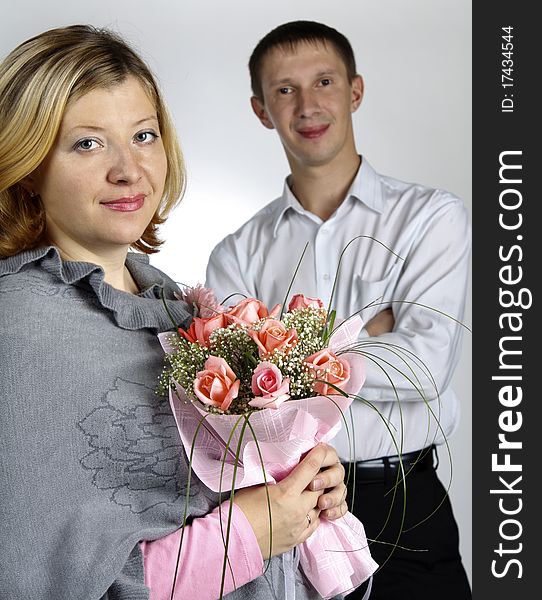 The man and the woman, the woman with a bunch of flowers, focus on the man