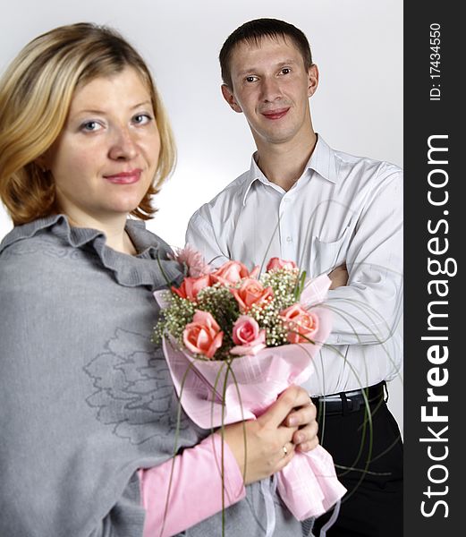 The man and the woman, the woman with a bunch of flowers, focus on the man