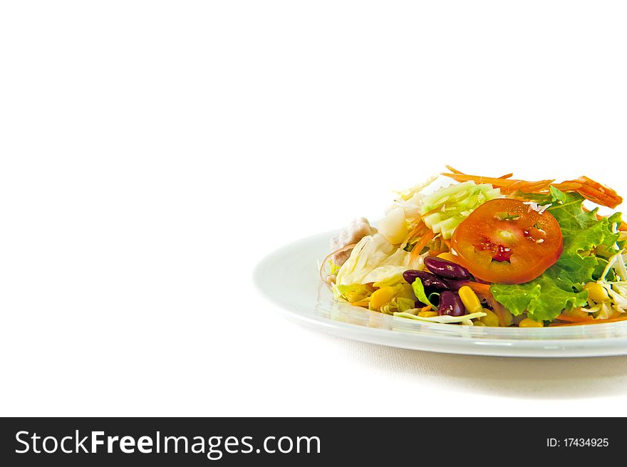 Mixed salad on white plate isolated on white for use as background