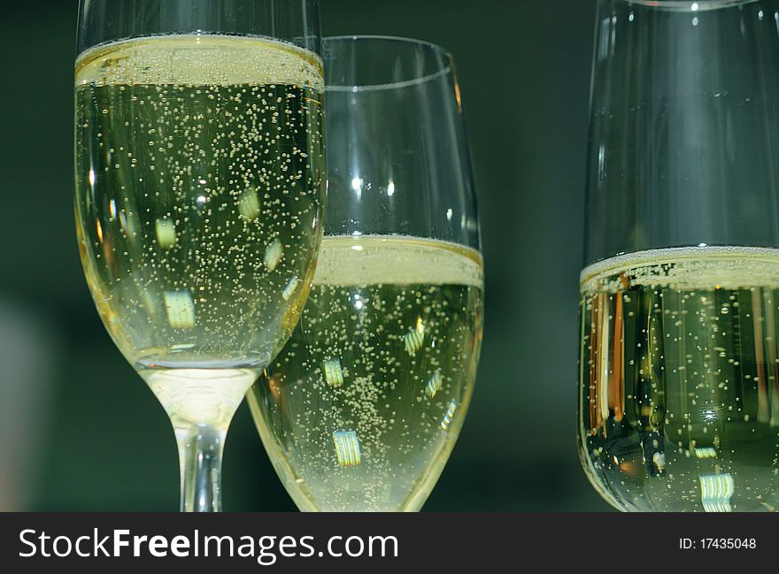 Bubbles in a glass of champagne at the holiday table. Bubbles in a glass of champagne at the holiday table