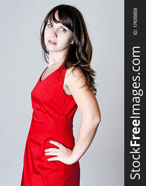 Beauty young woman in red dress with blue eyes