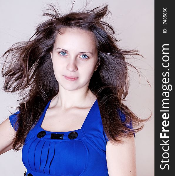 Beauty young woman in blue dress with blue eyes