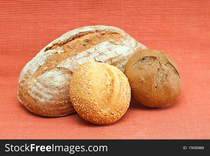 Fresh bread and buns on a red background. Fresh bread and buns on a red background.