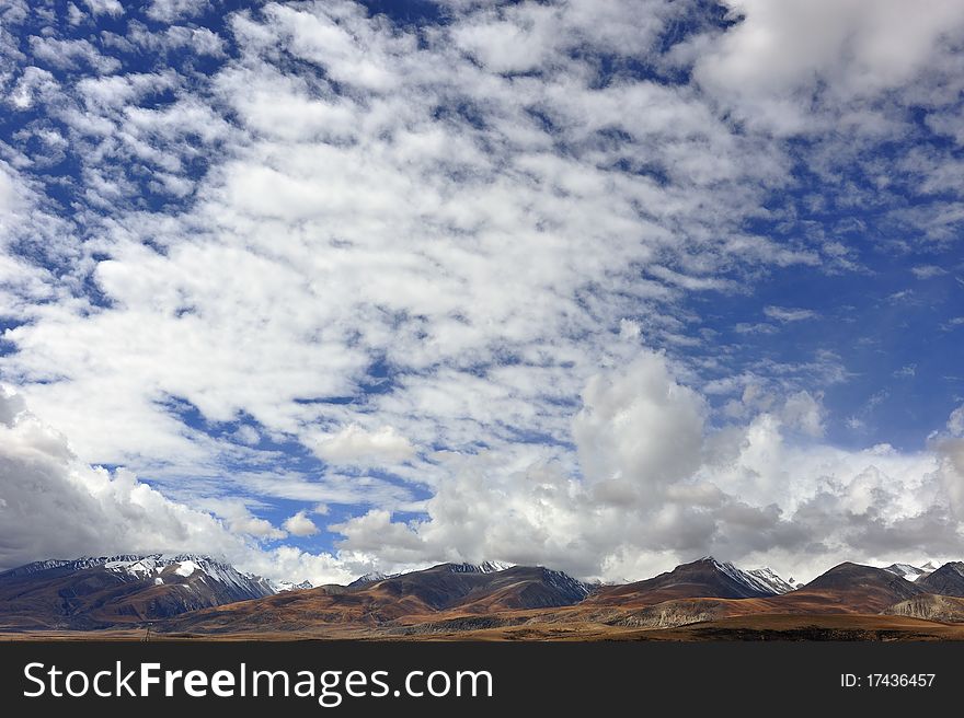 Plateau snowy mountains and clouds in the beautiful scenery