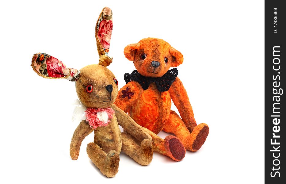 Vintage retro toys isolated on white. Teddy bear and rabbit.
