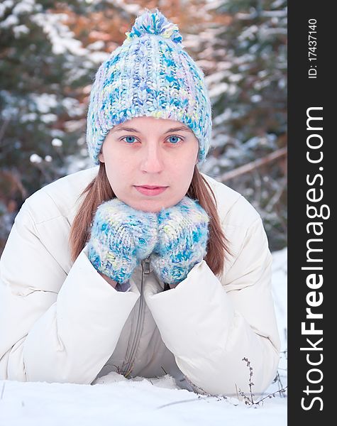 Winter girl behind snow tree