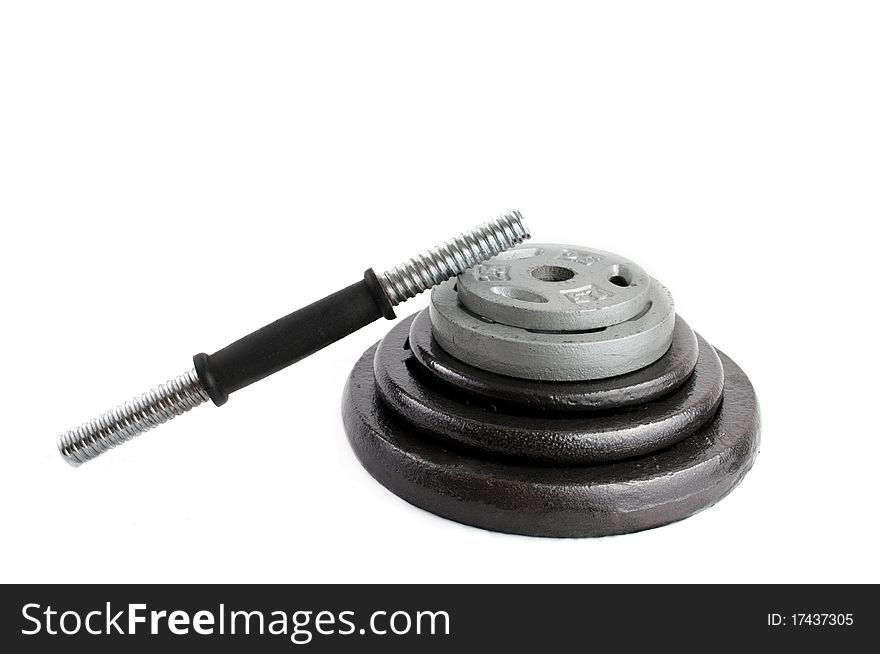 Different iron disc weights unit (plates) and Dumbbells empty bar isolated on white. Different iron disc weights unit (plates) and Dumbbells empty bar isolated on white