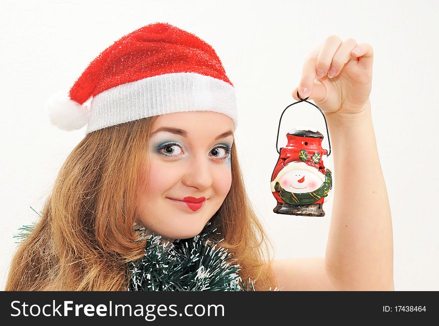 Smiling girl in Santa hat with lantern in hand. Smiling girl in Santa hat with lantern in hand