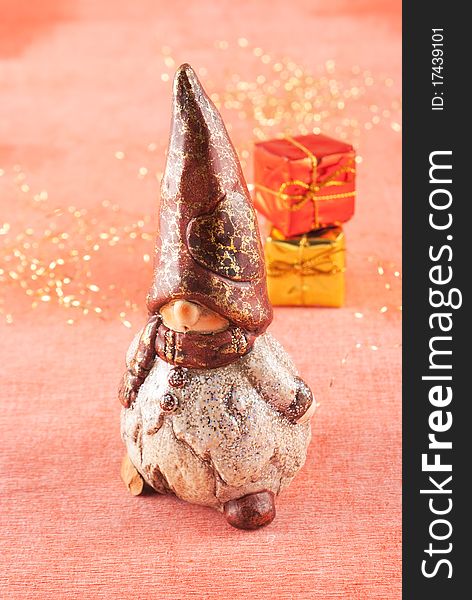 Christmas gnome with gifts on red bacground