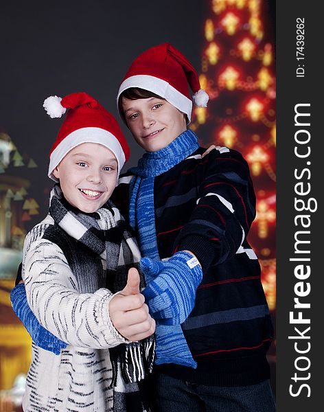 Two happy young boys on Christmas lights the background