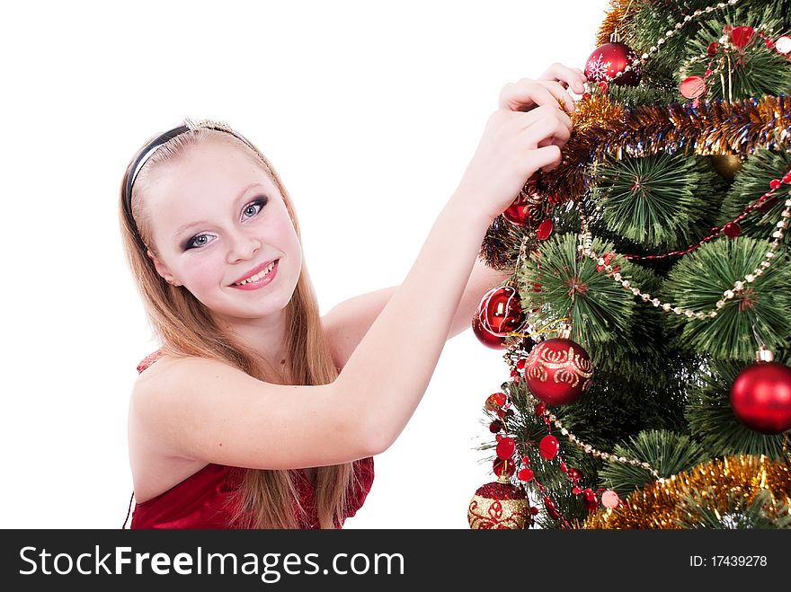 Beautiful girl decorating a Christmas tree. Beautiful girl decorating a Christmas tree