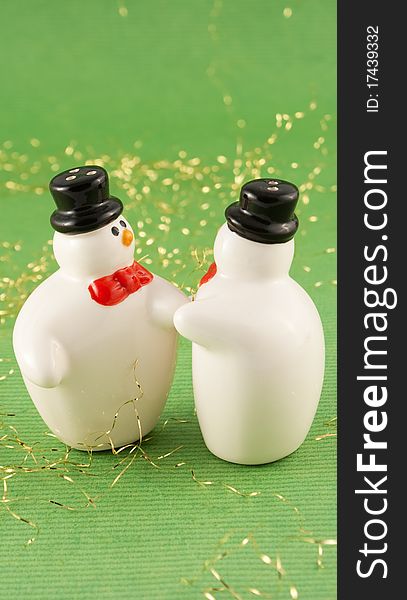 Christmas snowmans with hat on green background