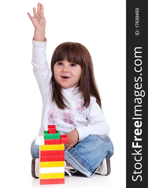 Cute little girl is constructing using building blocks